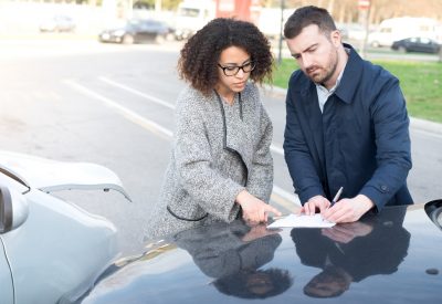 man and woman filling an insurance car form