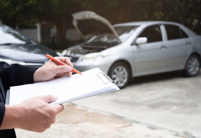 insurance officer agent working during on site car accident claim process