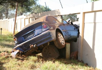 a motor vehicle car crashed through a brick wall at high speed